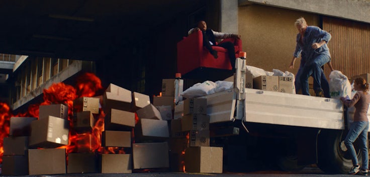 Idris Elba rides an armchair over an explosion in the ad from Sky and Vue