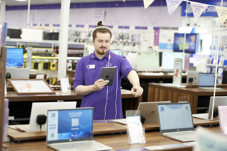 A Currys employee in store