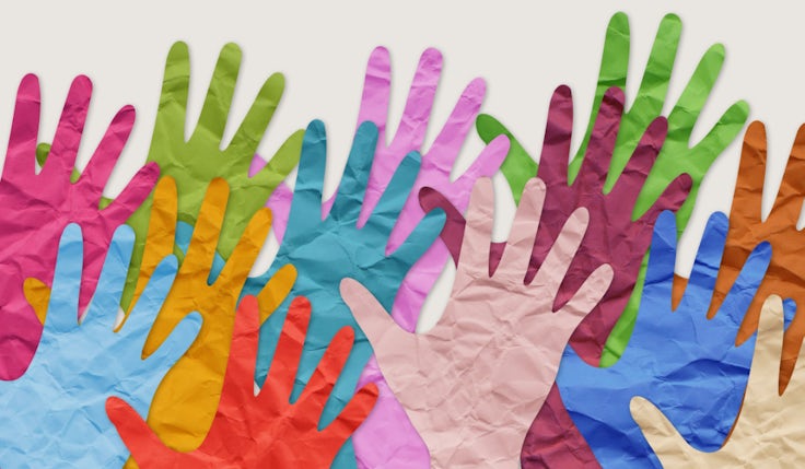 A picture of multiple hands to demonstrate an inclusive society