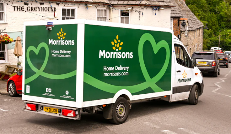 morrisons van delivering food in a village